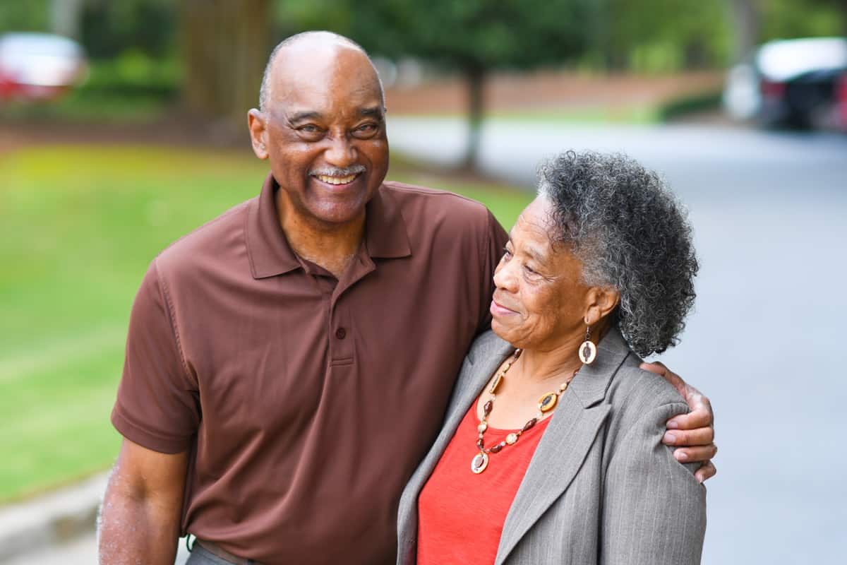 Senior couple living at Traditions of Mount Vernon enjoying a walk on the paved community walking paths